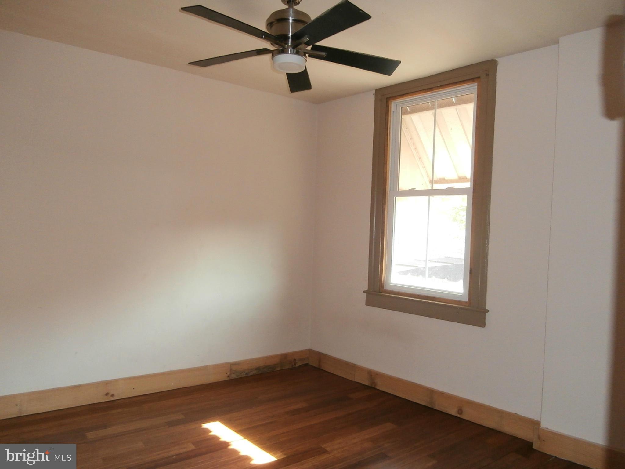 10 Blue Ridge Avenue, Unit 1 Front Royal, VA 22630 - Photo 5 of 7 an empty room with a window and a fan