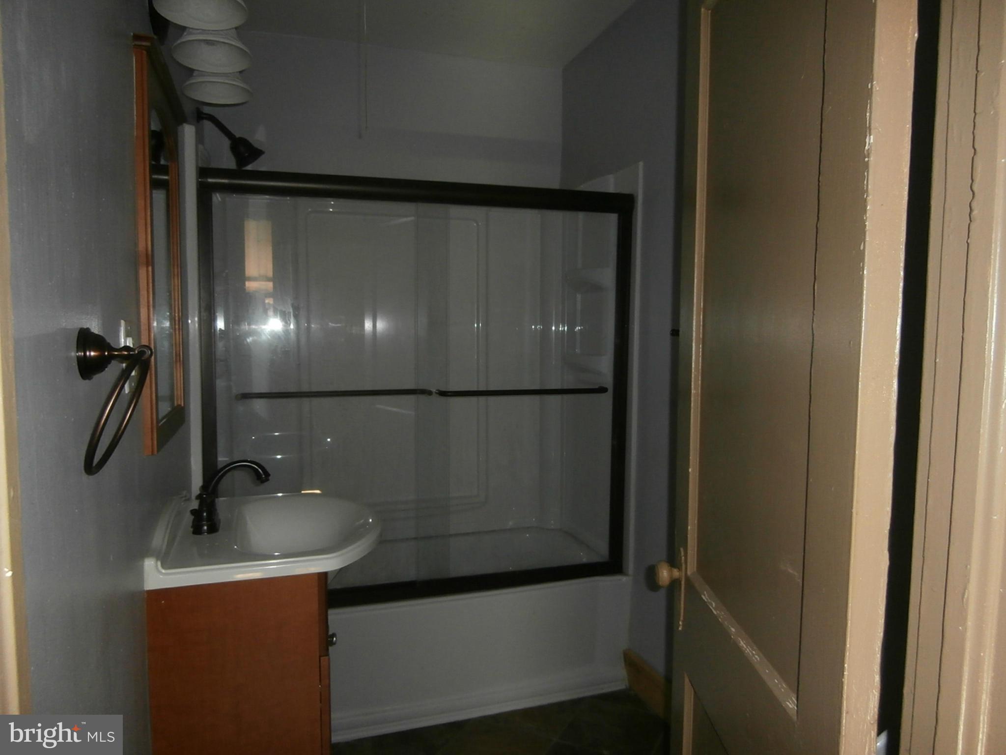 10 Blue Ridge Avenue, Unit 1 Front Royal, VA 22630 - Photo 7 of 7 a bathroom with a sink and mirror