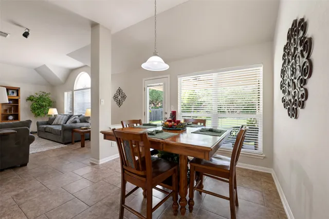 a view of a dining room with furniture and chandelier