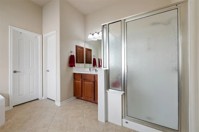 a bathroom with a tub double sink and mirror