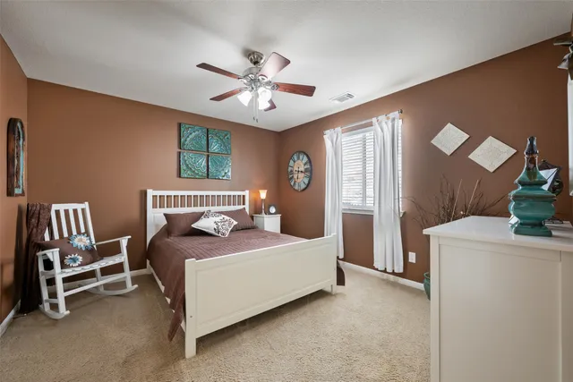 a spacious en suite bathroom with a double vanity sink mirror and bedroom