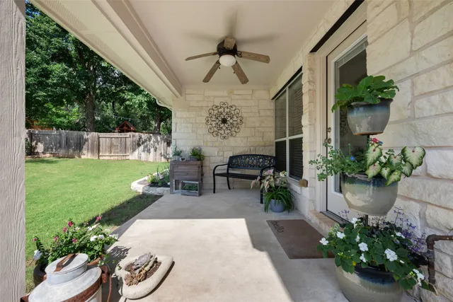 a view of a patio with a table chairs and a backyard