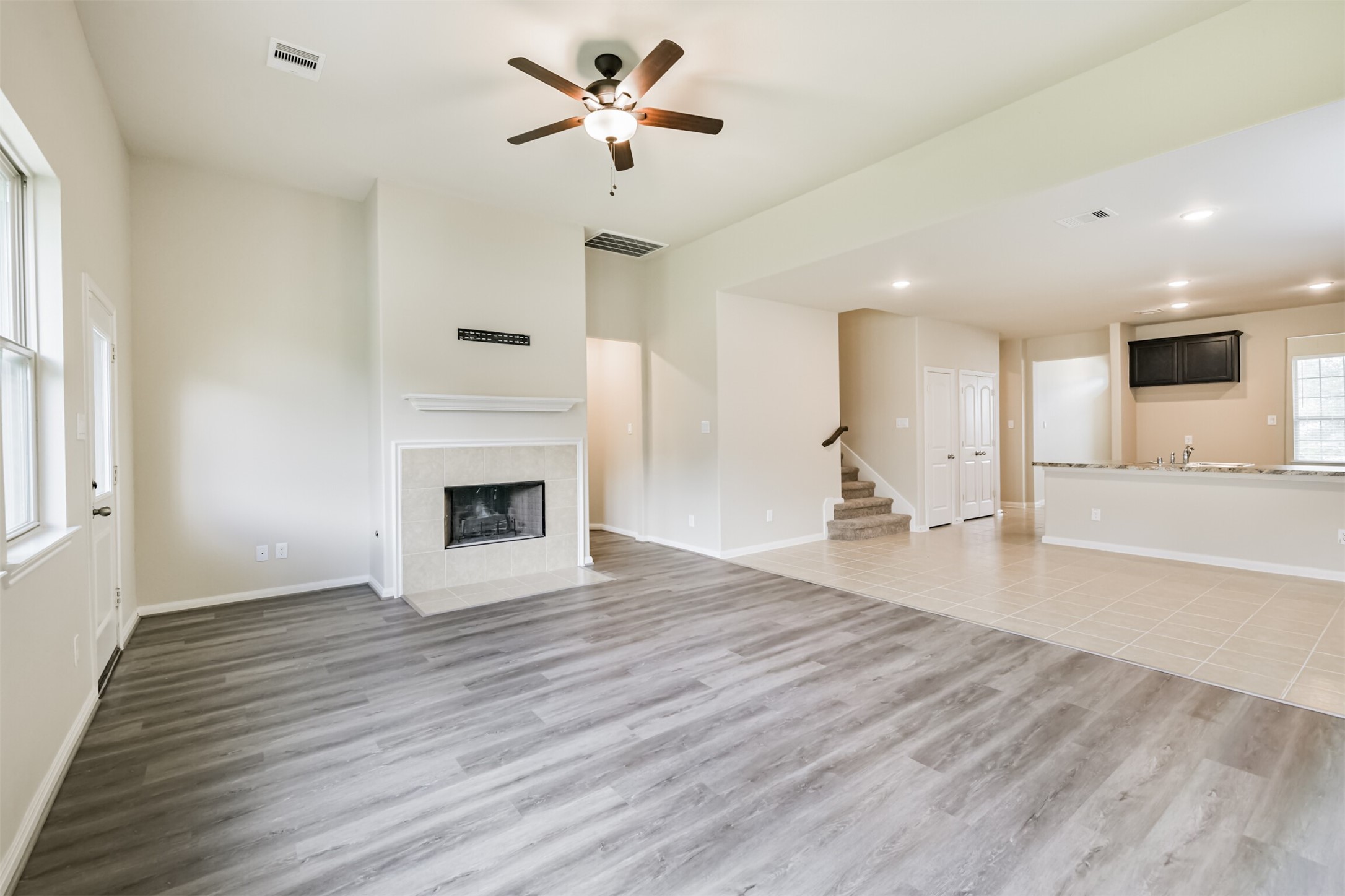 12638 Silver Winter Trail Houston, TX 77014 - Photo 6 of 35 This View Shows the Living Room and Dining Room Combo. An Open Kitchen Design with Sight-Lines Means No One is Left Out While the Party's in Full Swing! The Ceiling Height and Change of Flooring Help to Visually Delineate the Two Spaces!