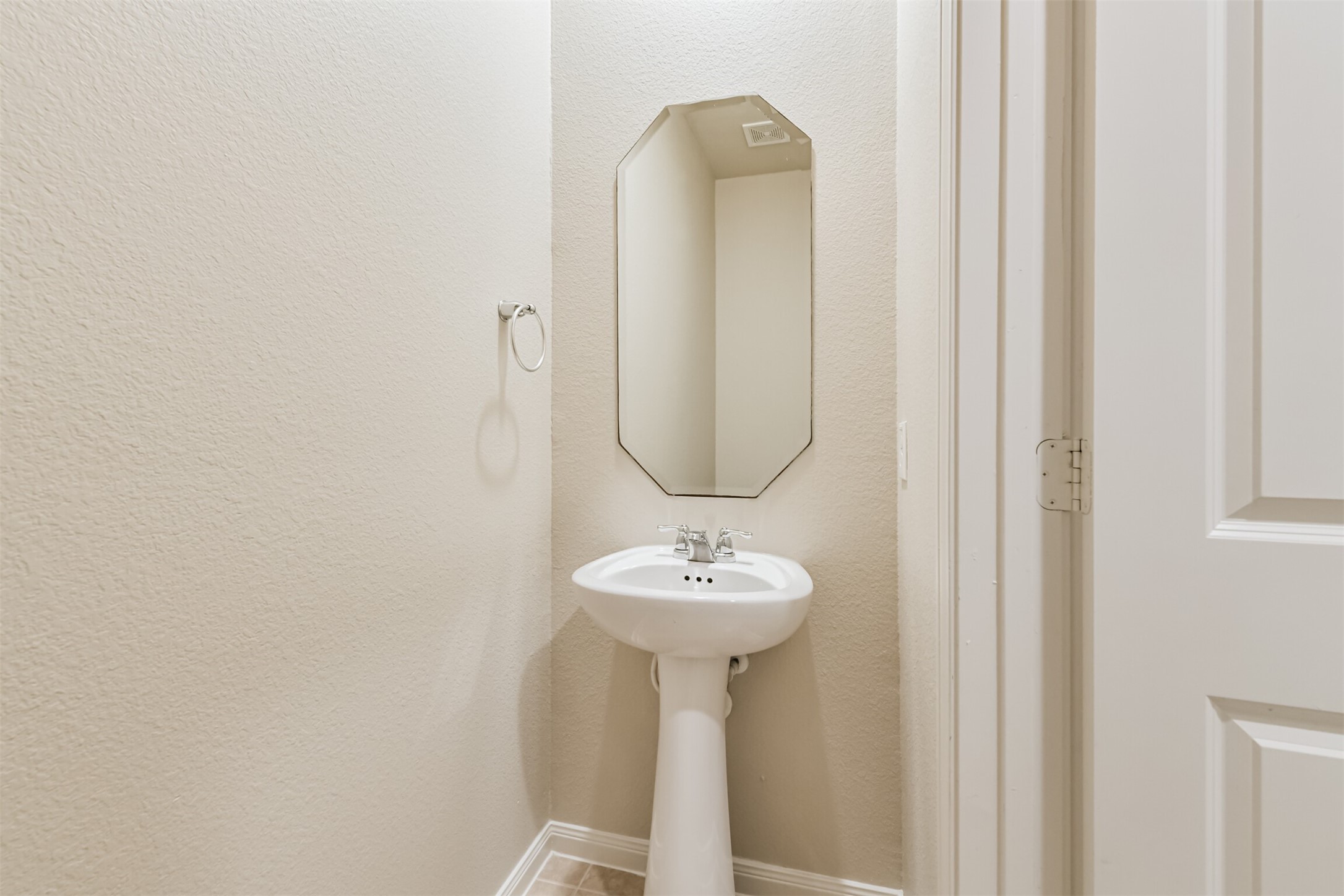 12638 Silver Winter Trail Houston, TX 77014 - Photo 7 of 35 A First Floor Powder Room Keeps Visitors Out of Your Personal Bedroom Space in the Downstairs Primary Bathroom! Note the Upgraded Panel Doors Throughout the Home!