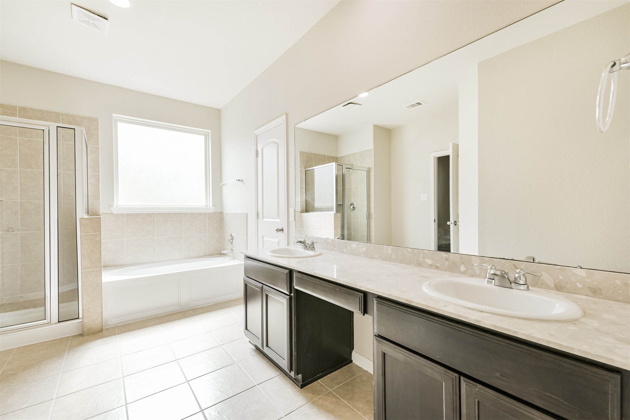 12638 Silver Winter Trail Houston, TX 77014 - Photo 9 of 35 Primary Bath has Both a Luxury Soaking Tub and Separate Shower! Love the Large Mirror, Seated Makeup Space and Dual Sinks!