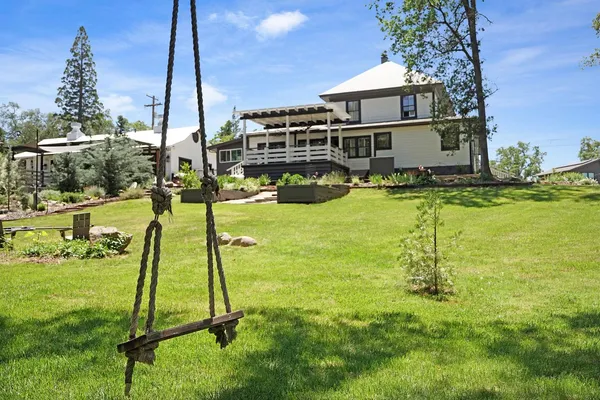 a house view with a play ground in front of it