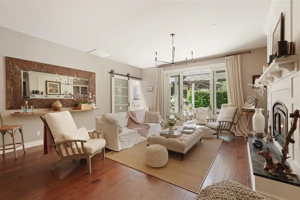 a living room with furniture gym equipment and a floor to ceiling window