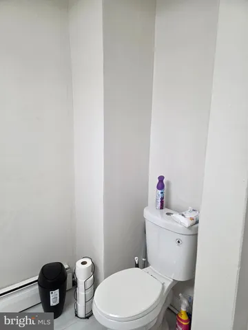 a white toilet sitting next to a bathroom sink