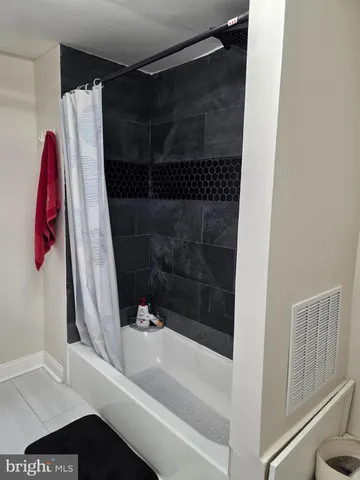 a bathroom with a shower and a tub