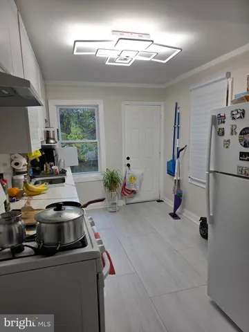 a kitchen with a sink appliances and cabinets