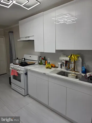 a kitchen with stainless steel appliances granite countertop a sink a stove and cabinets