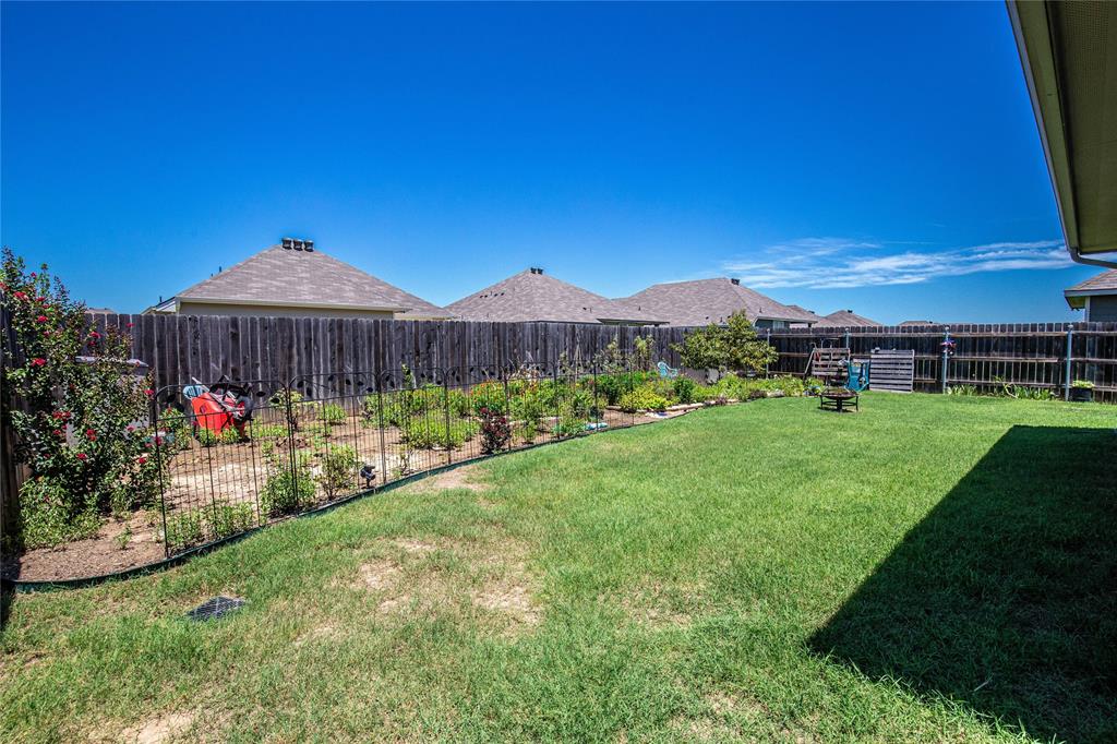 4028 Bravo Ranch Road Waco, TX 76705 - Photo 14 of 19 a view of a garden with a bench under an umbrella