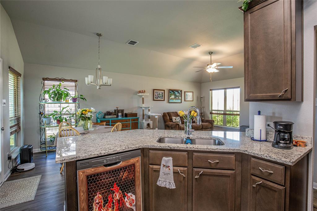4028 Bravo Ranch Road Waco, TX 76705 - Photo 6 of 19 a kitchen with granite countertop a sink a counter space and cabinets
