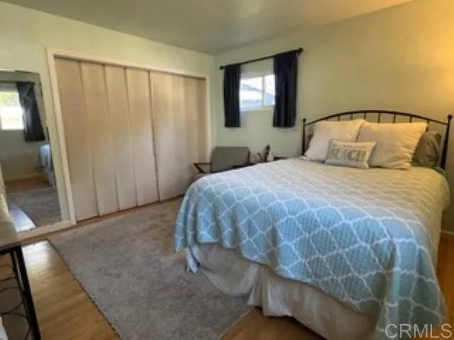 a bedroom with a bed and a mirror