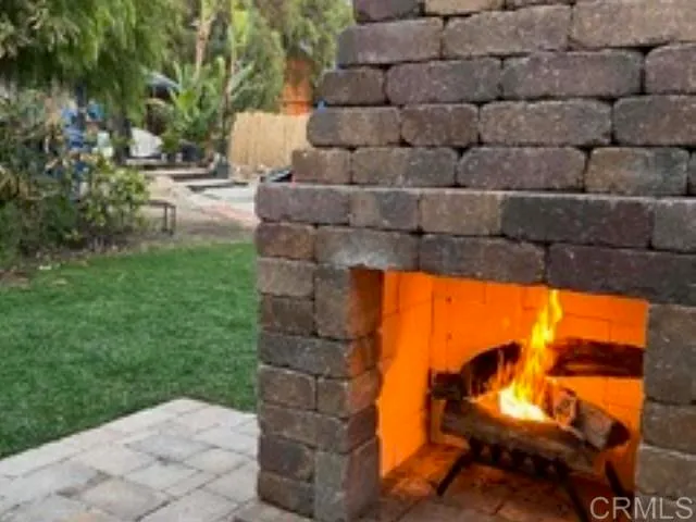 a backyard of a house with table and chairs