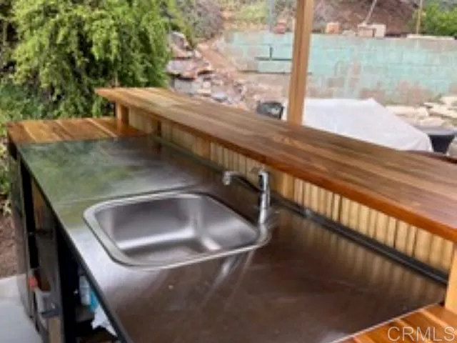 a view of a patio with table and chairs and potted plants
