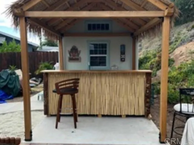 a view of a patio with table and chairs a barbeque grill and a fireplace