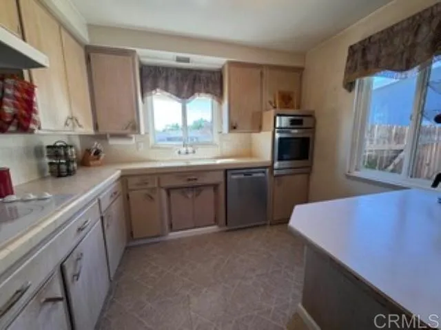 a kitchen with stainless steel appliances a sink stove and refrigerator