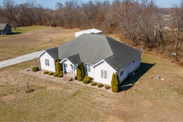 a aerial view of a house with a yard covered in snow