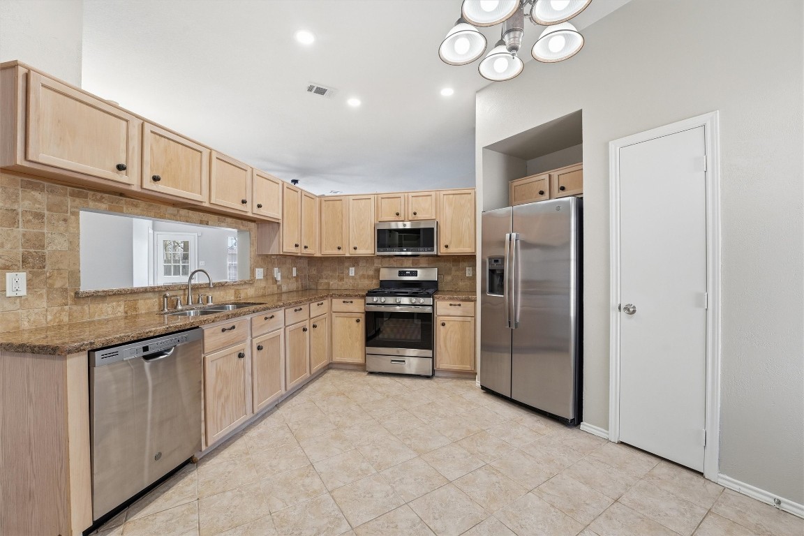 2618 Heather Knoll Drive Spring, TX 77373 - Photo 13 of 32 a kitchen with granite countertop a refrigerator oven a sink and dishwasher