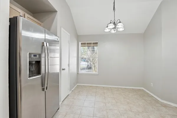 a kitchen with stainless steel appliances granite countertop a refrigerator and a stove