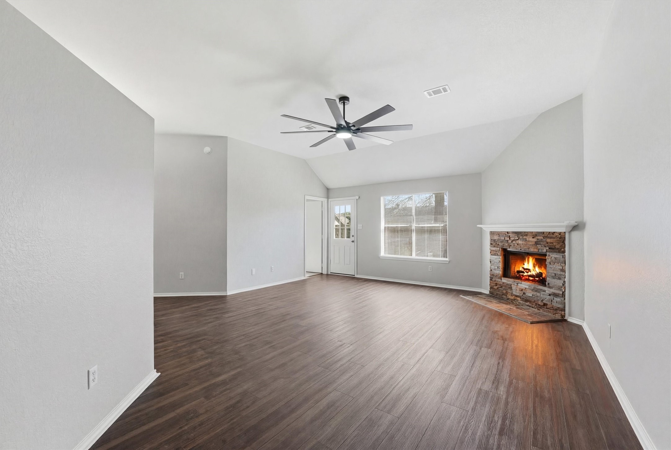 2618 Heather Knoll Drive Spring, TX 77373 - Photo 8 of 32 an empty room with wooden floor a ceiling fan and windows