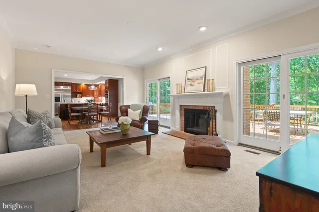 a living room with furniture potted plant and a large window