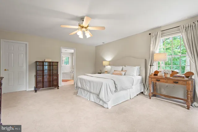 a spacious bathroom with a granite countertop sink a mirror and a bathtub
