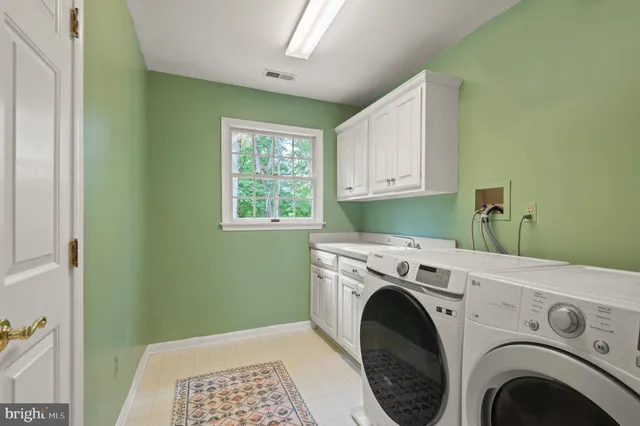 an empty room with windows and ceiling fan