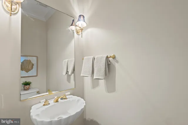 a kitchen with stainless steel appliances granite countertop wooden cabinets a sink a stove a dining table and chairs