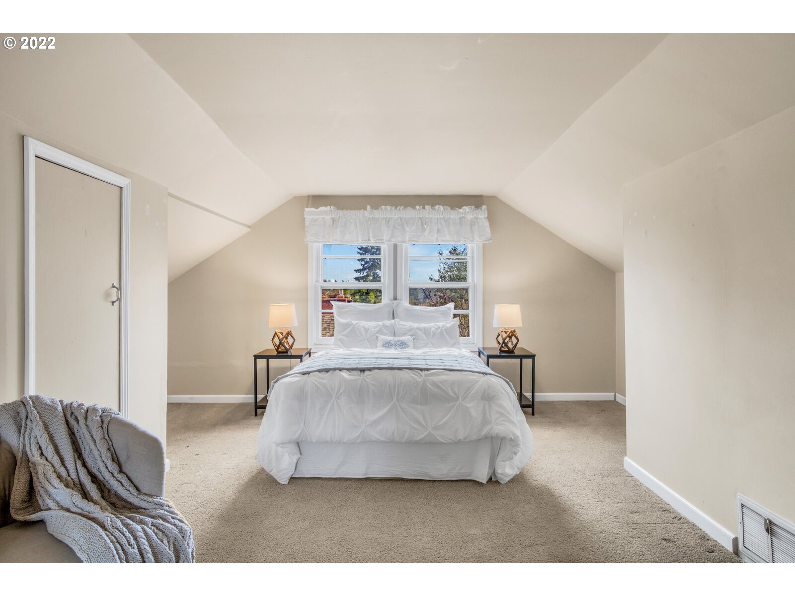 3330 Southwest Primrose Street Portland, OR 97219 - Photo 19 of 26 a bedroom with a bed and window