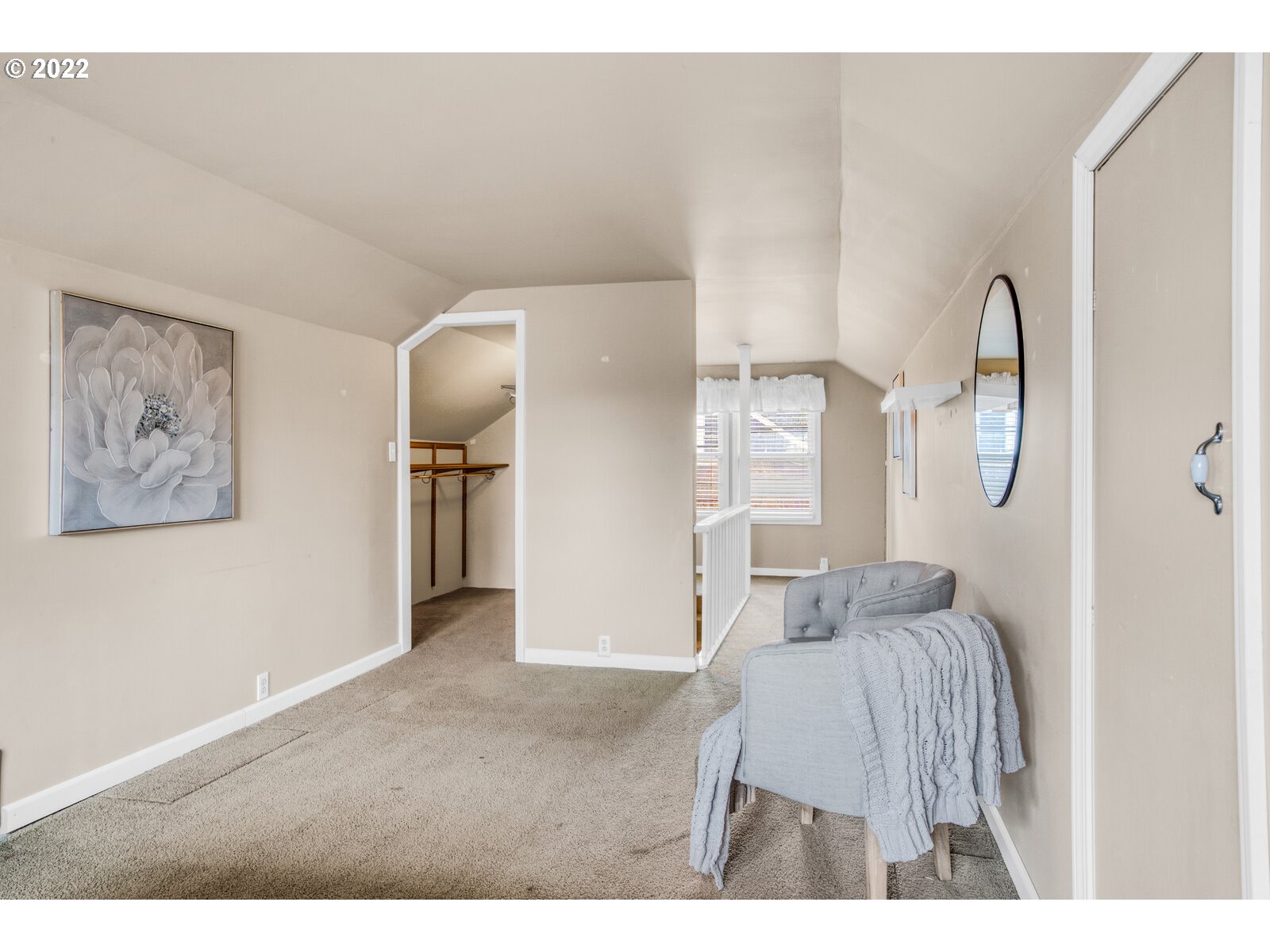 3330 Southwest Primrose Street Portland, OR 97219 - Photo 20 of 26 a bedroom with a bed and a chandelier