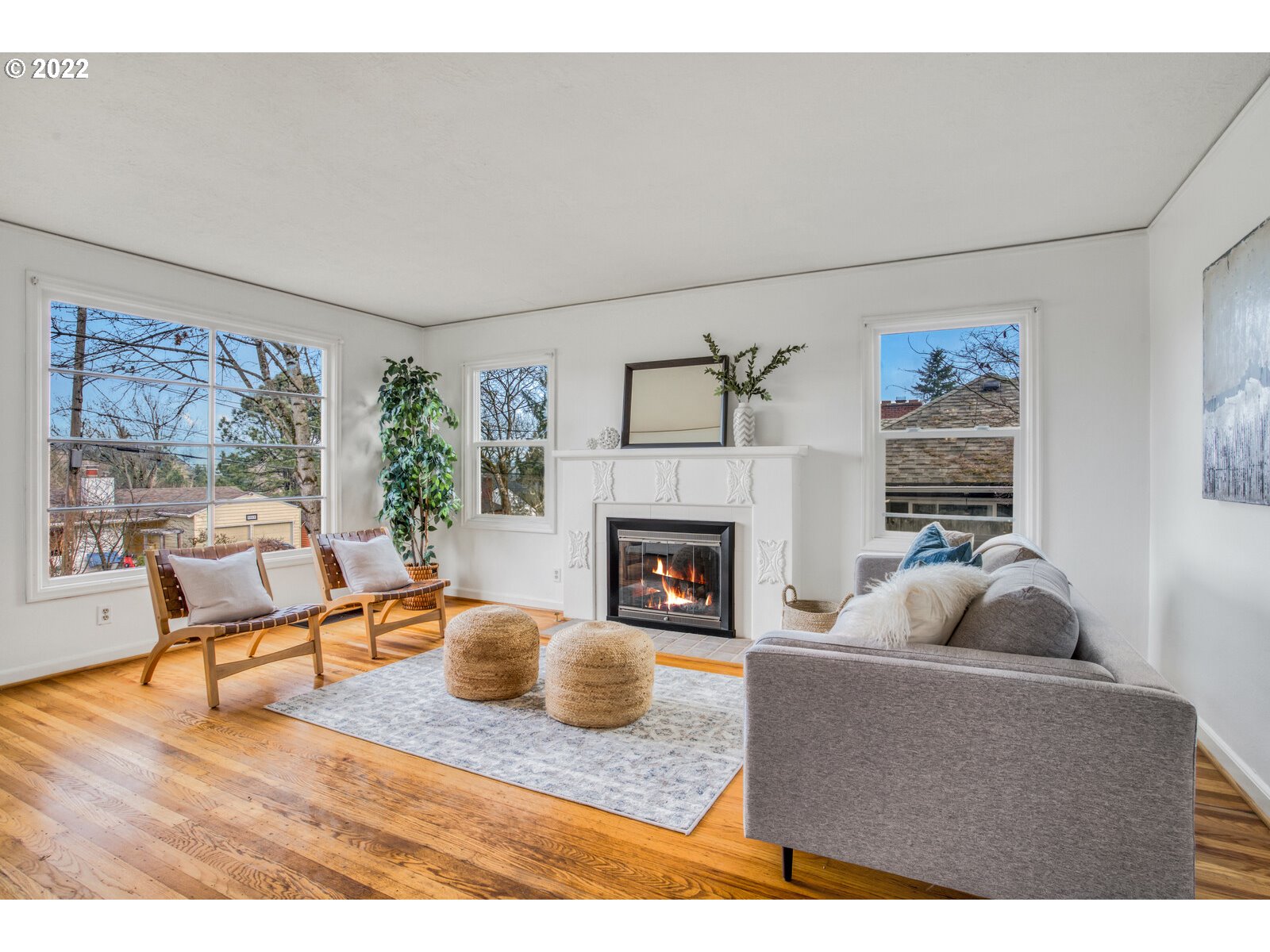 3330 Southwest Primrose Street Portland, OR 97219 - Photo 2 of 26 a living room with furniture a fireplace and a large window