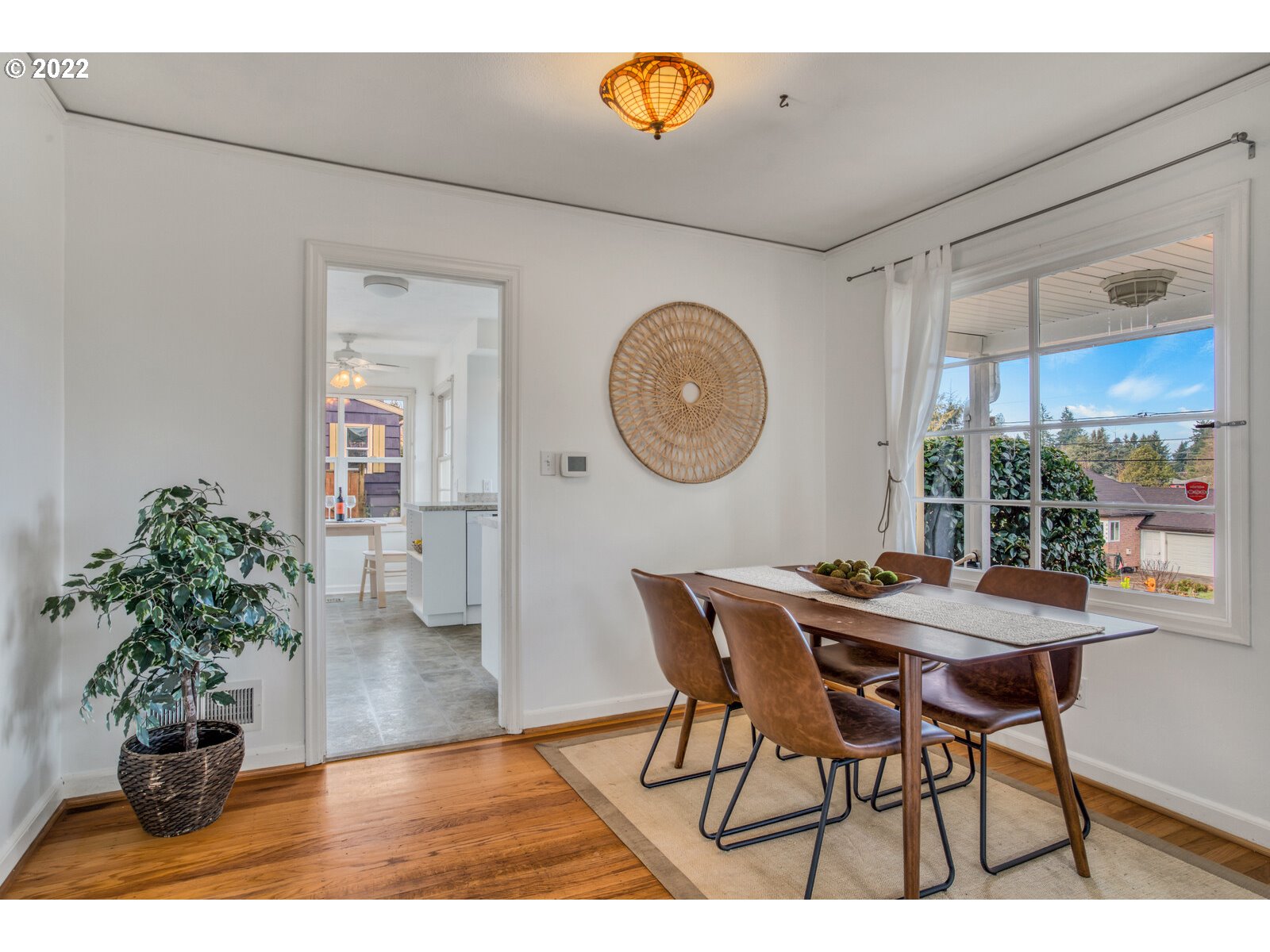 3330 Southwest Primrose Street Portland, OR 97219 - Photo 5 of 26 a dining room with furniture and a clock