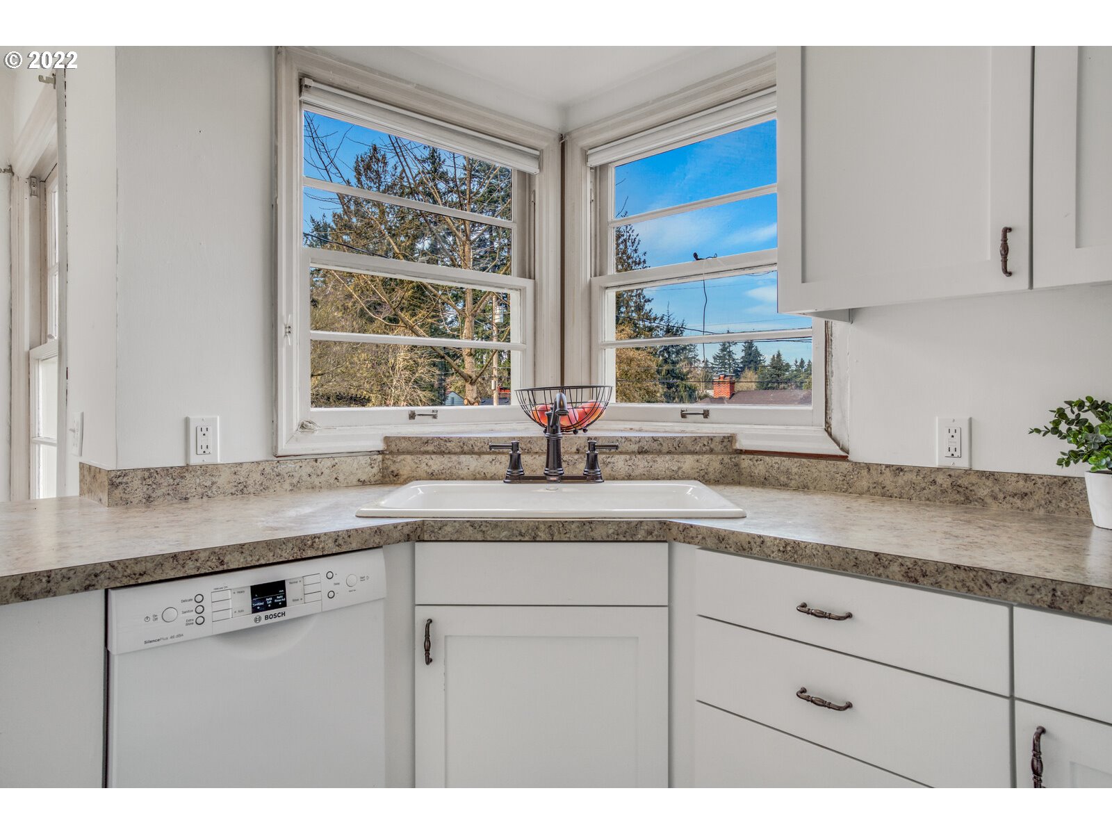 3330 Southwest Primrose Street Portland, OR 97219 - Photo 9 of 26 a kitchen with granite countertop white cabinets and a sink
