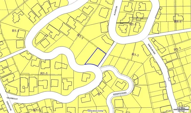 a view of a big yard with plants and large trees