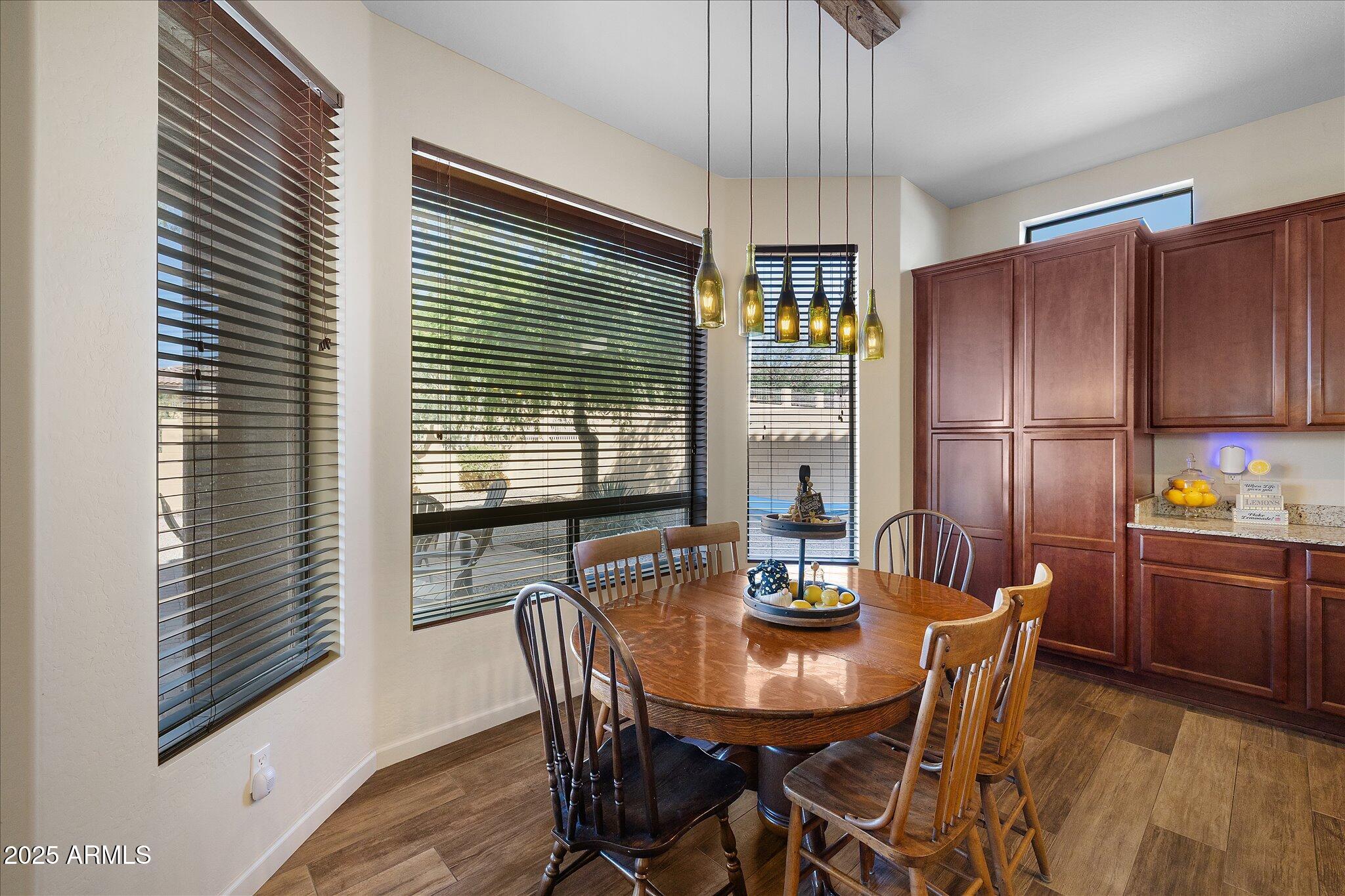 8536 East Inca Street Mesa, AZ 85207 - Photo 11 of 44 a view of a dining room with furniture window and wooden floor