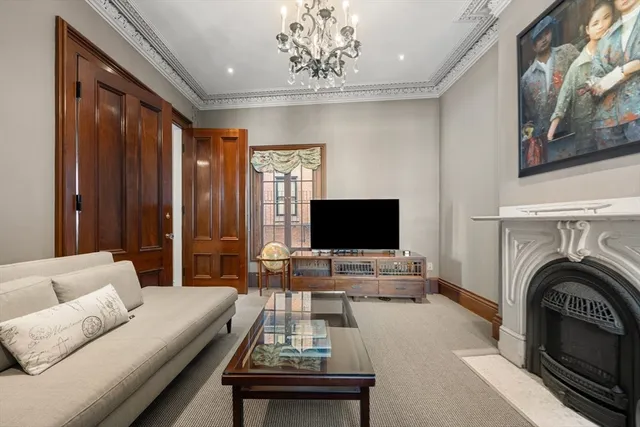 a bedroom with a bed wooden floor and window