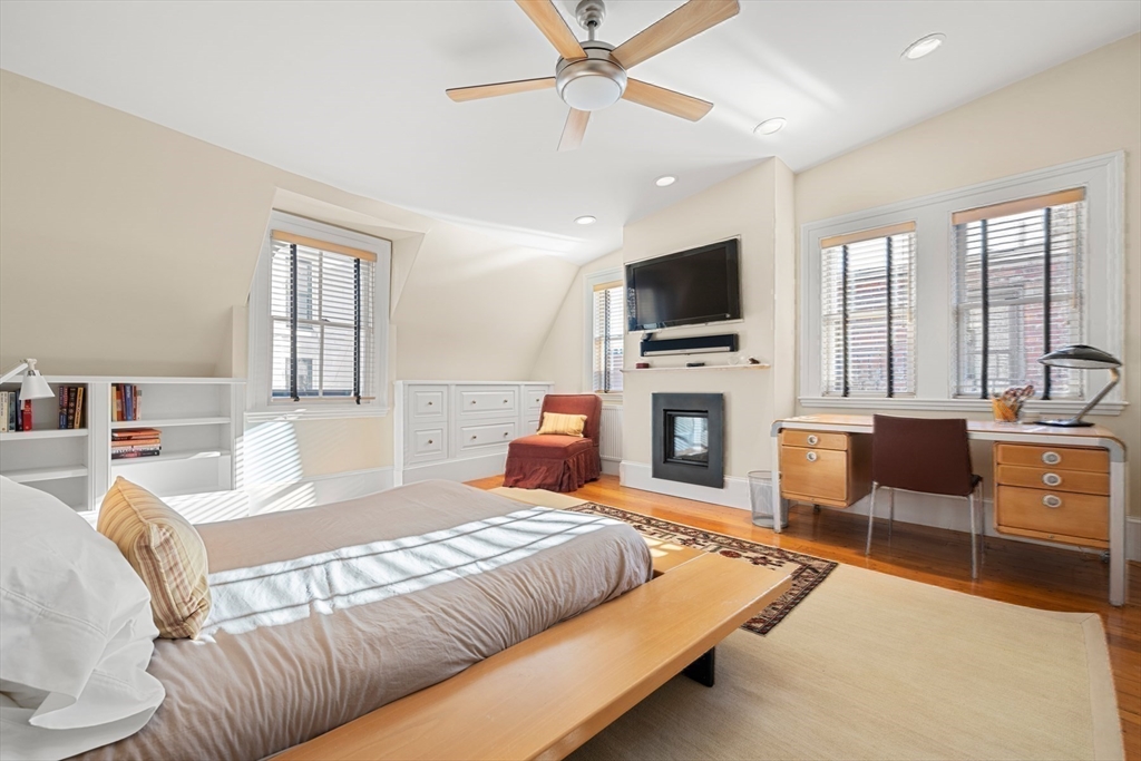 54 Union Park Boston, MA 02116 - Photo 22 of 35 a bedroom with a bed a flat screen tv and a fireplace