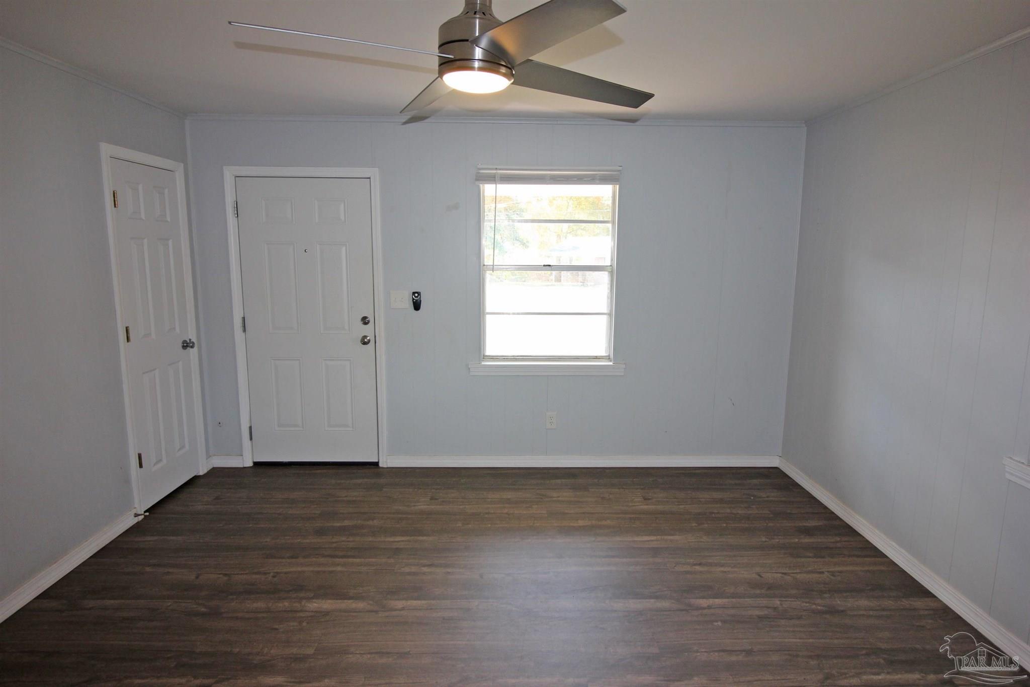 141 Holt Street Flomaton, AL 36441 - Photo 14 of 28 wooden floor in an empty room with a window