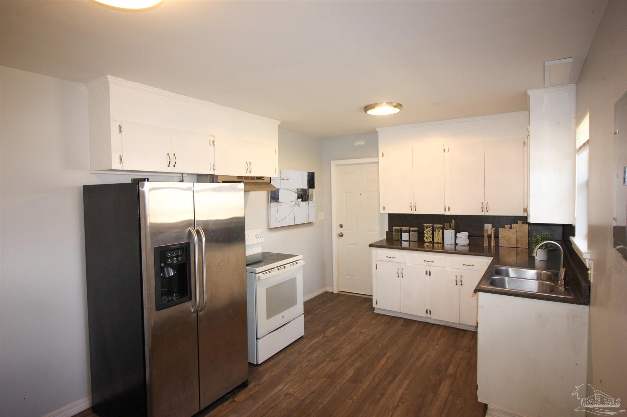 141 Holt Street Flomaton, AL 36441 - Photo 15 of 28 a kitchen with a refrigerator sink and cabinets