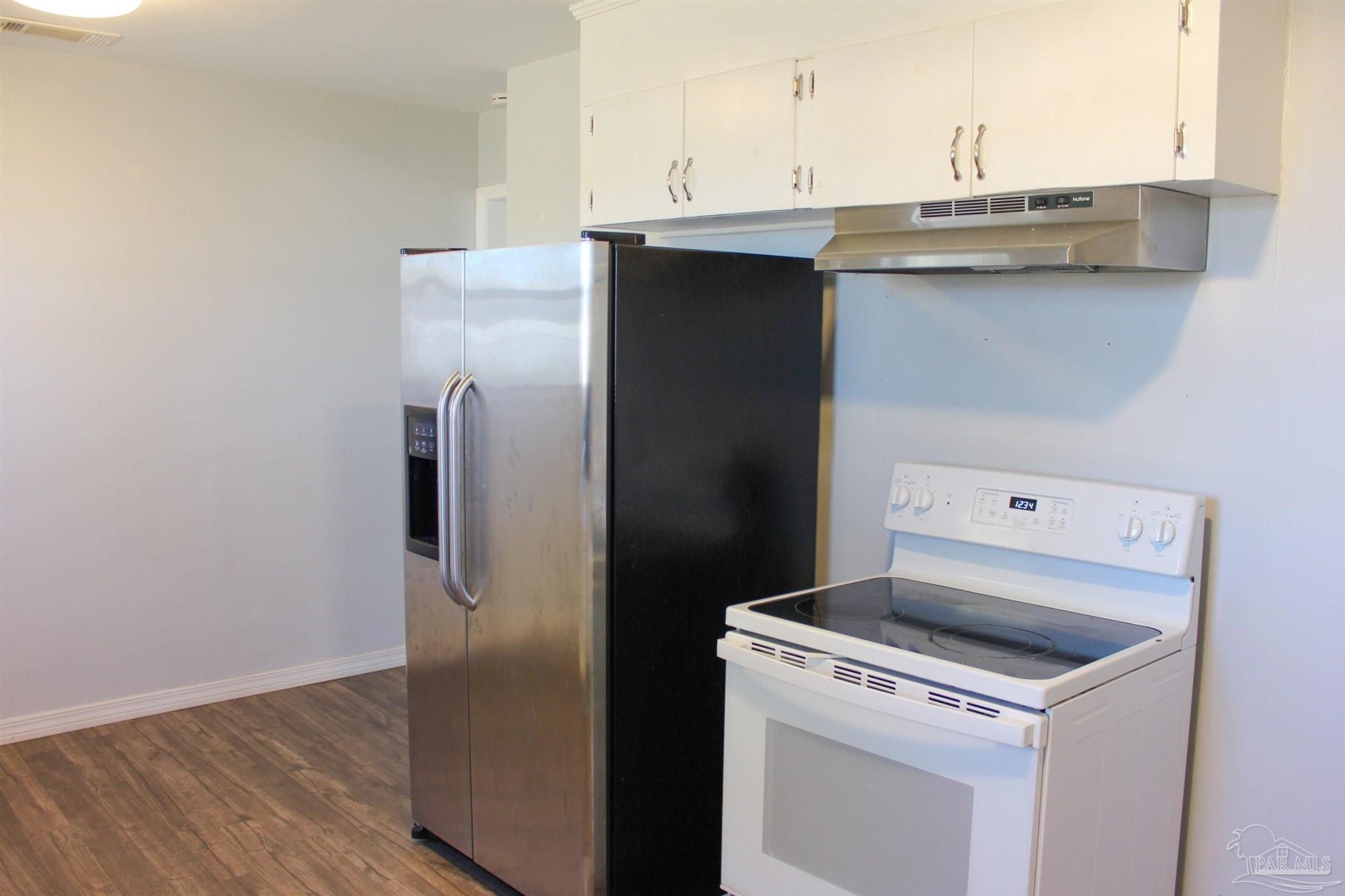 141 Holt Street Flomaton, AL 36441 - Photo 17 of 28 a kitchen with a sink and a refrigerator