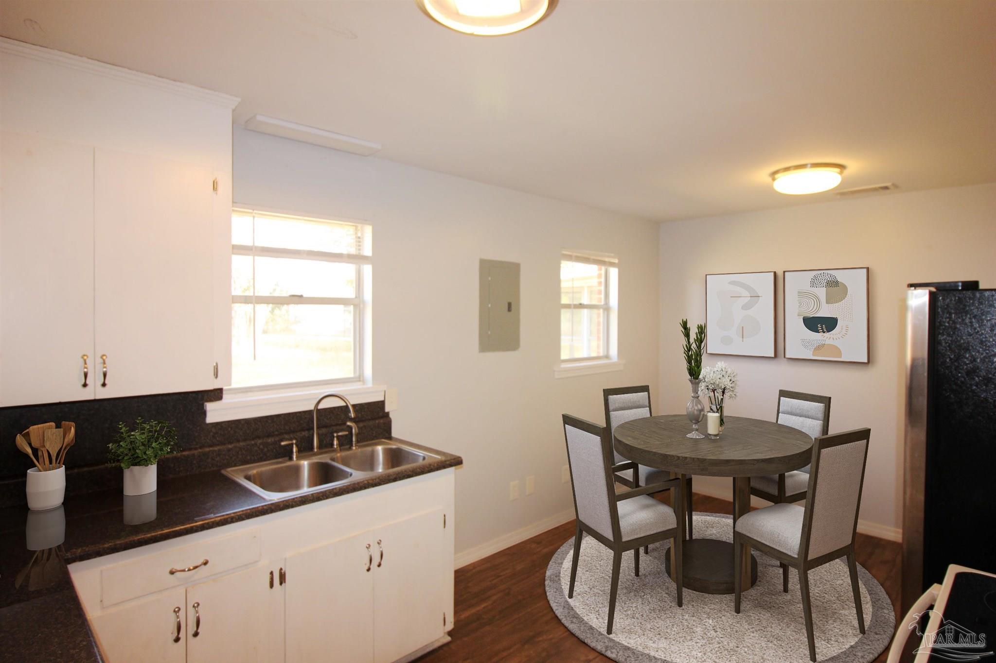 141 Holt Street Flomaton, AL 36441 - Photo 18 of 28 a kitchen with a sink cabinets and wooden floor
