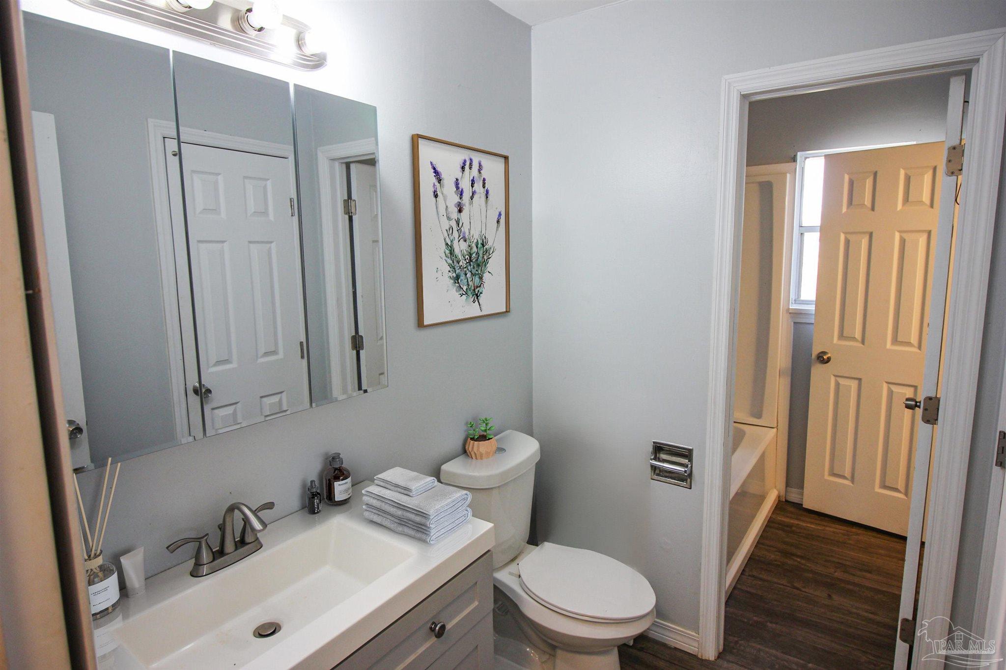 141 Holt Street Flomaton, AL 36441 - Photo 22 of 28 a bathroom with a sink mirror vanity and toilet