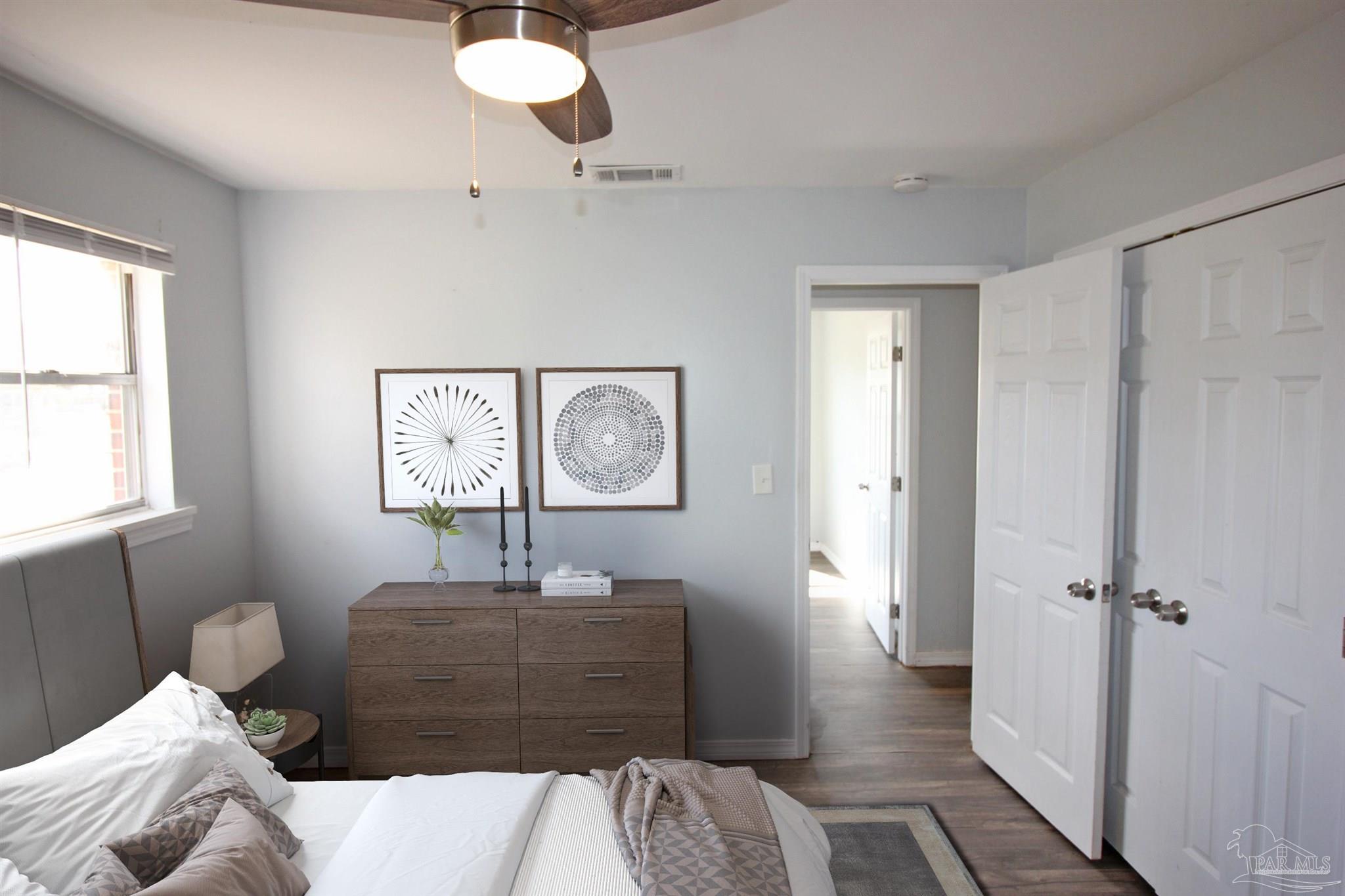 141 Holt Street Flomaton, AL 36441 - Photo 23 of 28 a bedroom with a bed and wooden floor