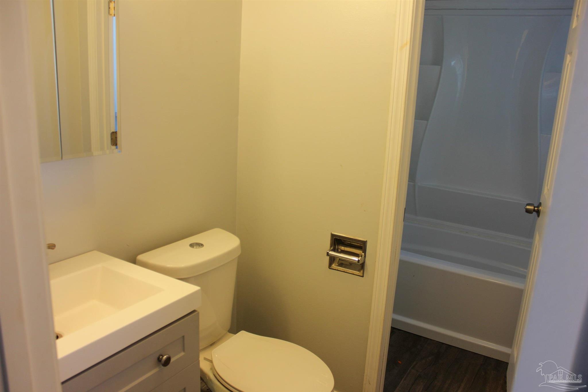 141 Holt Street Flomaton, AL 36441 - Photo 25 of 28 a white toilet sitting next to a shower in a bathroom