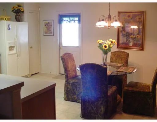 a view of hall way with furniture and chandelier