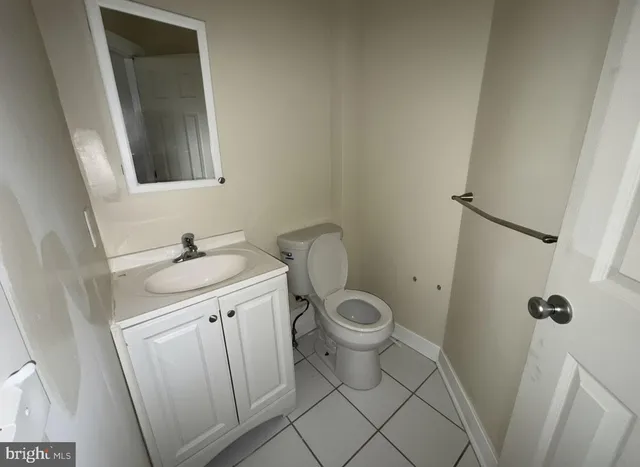 a bathroom with a sink toilet and a mirror