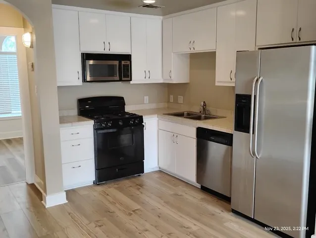 a kitchen with a refrigerator stove and microwave