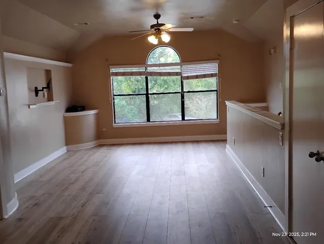 wooden floor in an empty room with a window